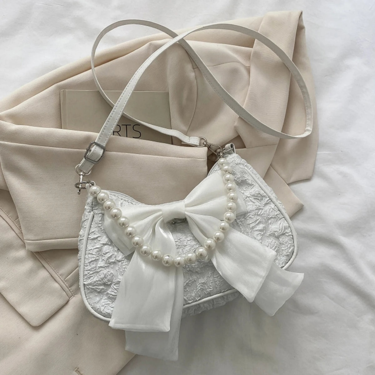 White folds pop retro bow bag Female Pearl handle New fashion pearl armpit shoulder crossbody bag 1 outfit